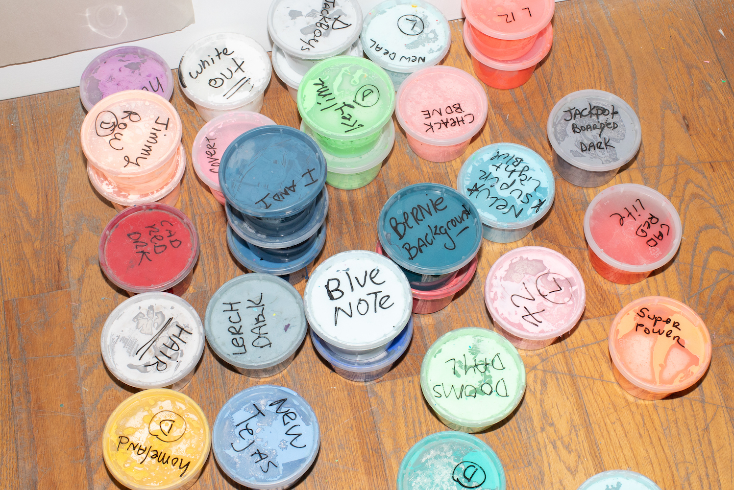 plastic containers of paint in erik parker's nyc studio