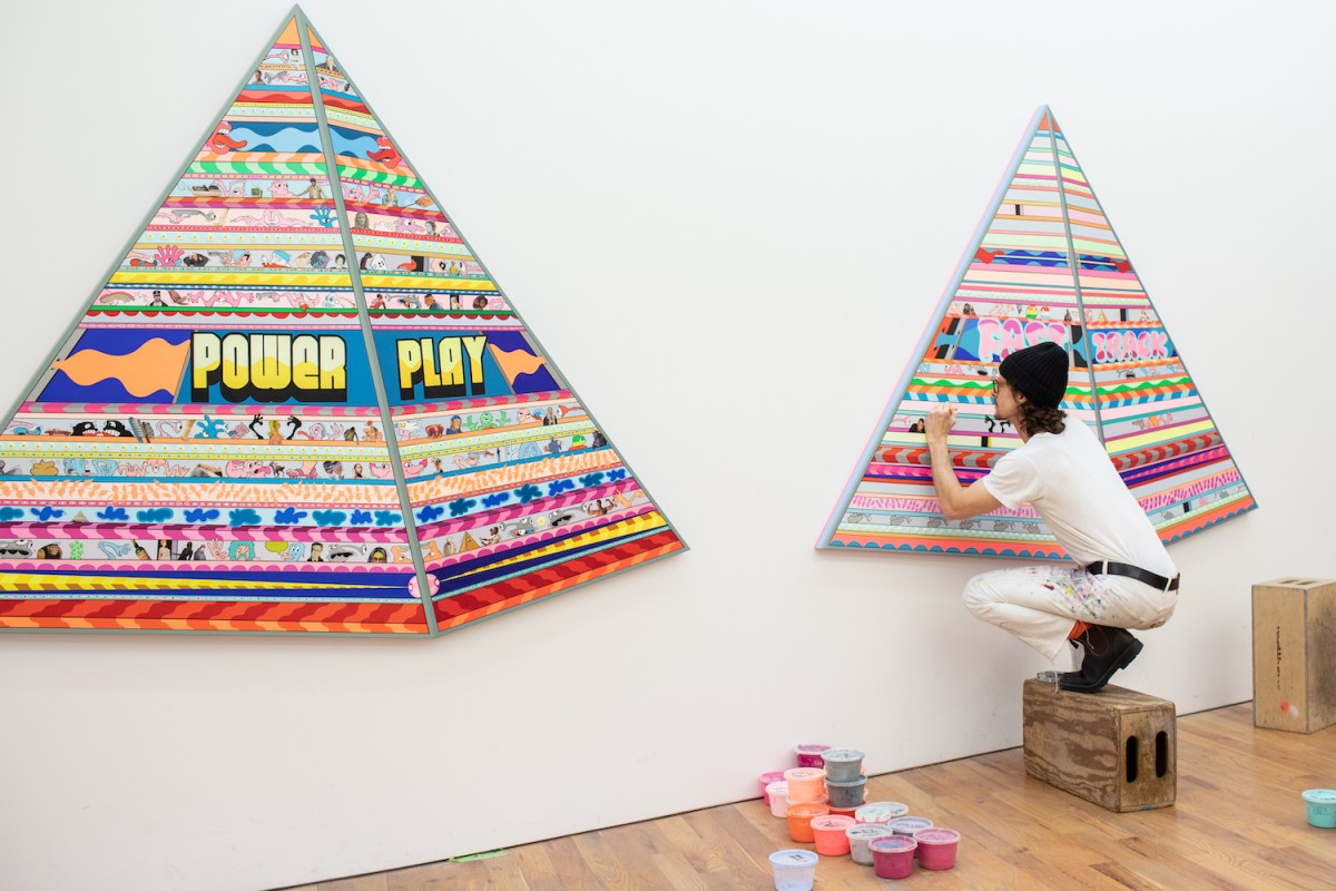 artist erik parker paints a set of two neon pyramids in his nyc studio