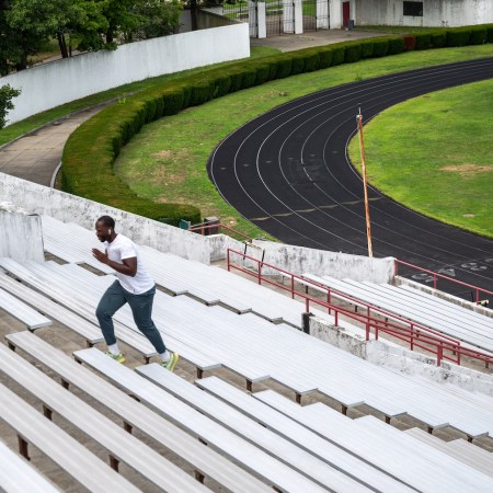A man sprints up stadium steps.