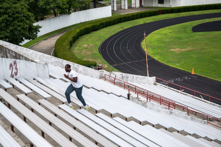 A man sprints up stadium steps.