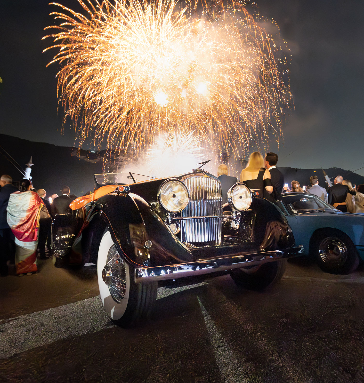 The 1935 Duesenberg SJ Speedster that won best in show at the Villa d'Este concours in 2023, with fireworks going off over Lake Como in the background