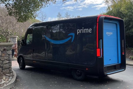 An Amazon electric delivery truck, developed by electric vehicle maker Rivian, makes deliveries in a residential neighborhood in Lafayette, California, with Amazon Prime logo visible, December 20, 2022.