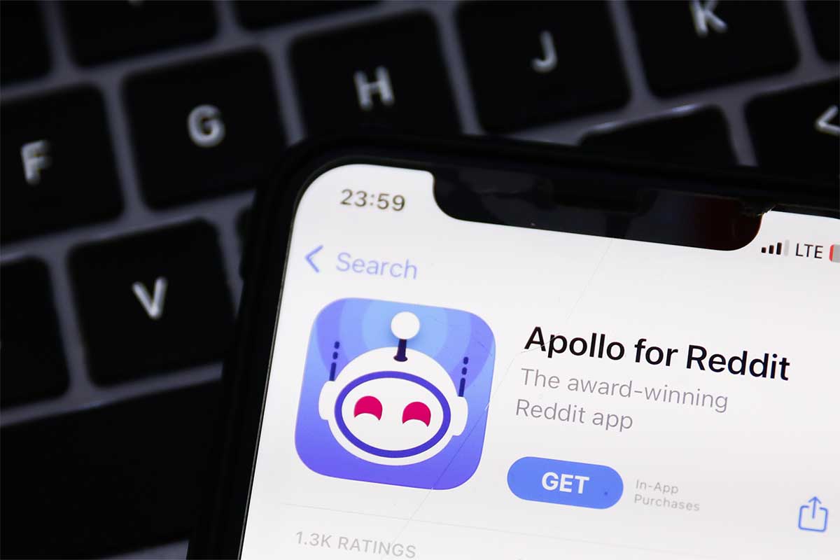 A laptop keyboard and Apollo for Reddit on AppStore displayed on a phone screen are seen in this illustration photo taken in Krakow, Poland on June 8, 2023
