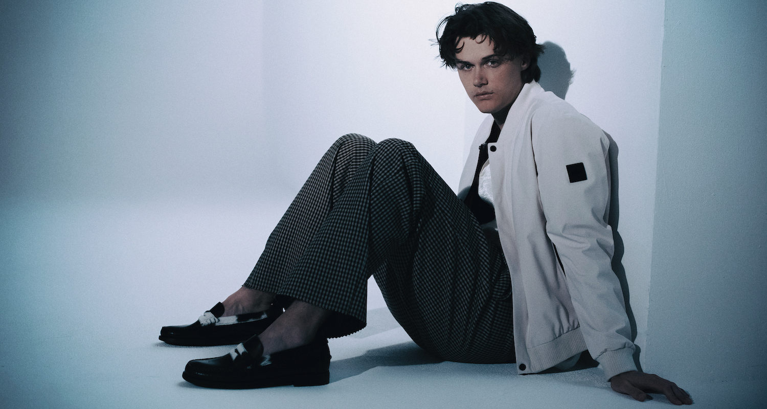 a photo of actor Chris Briney in a white jacket against a white background