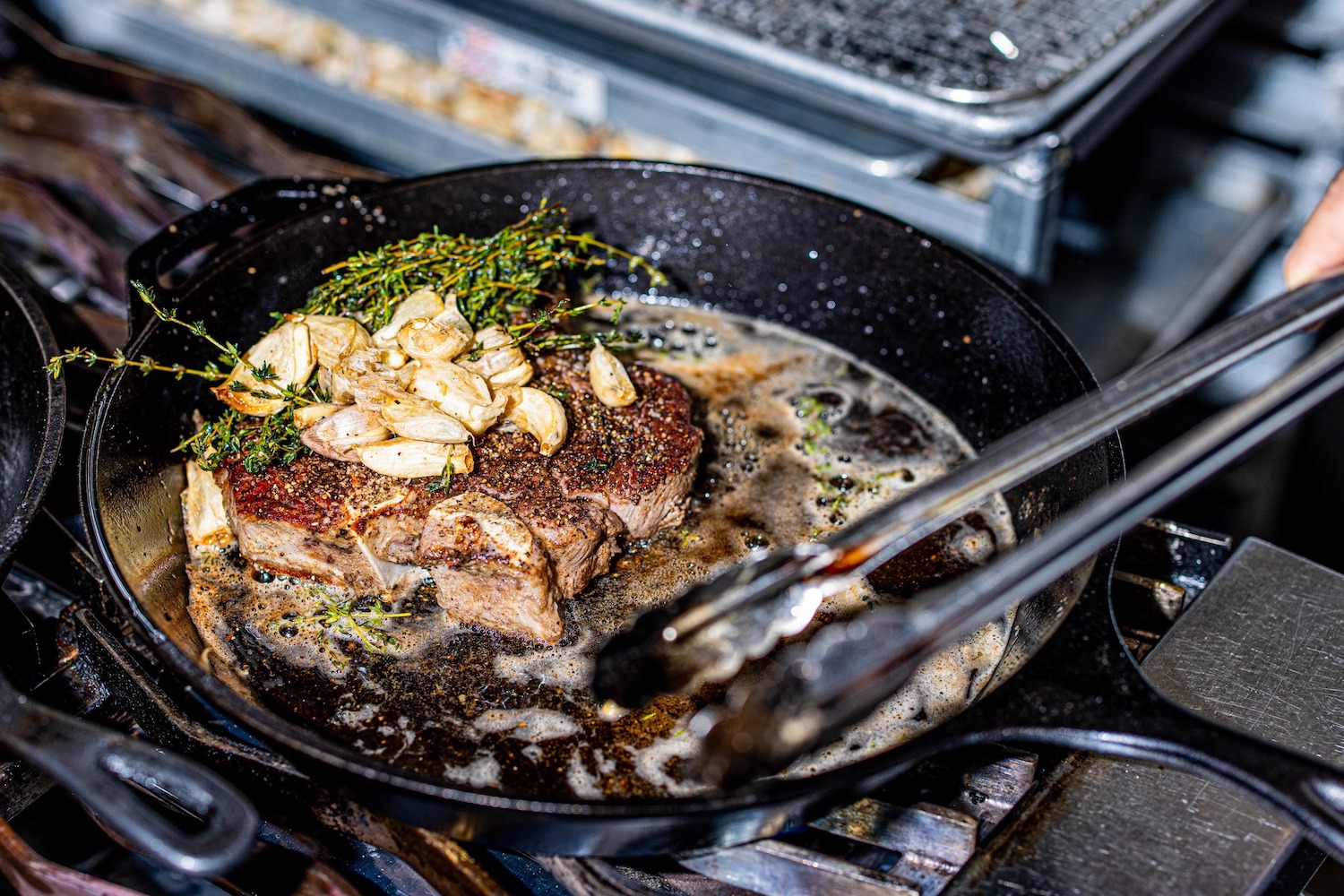 Steak being cooked in a pan.