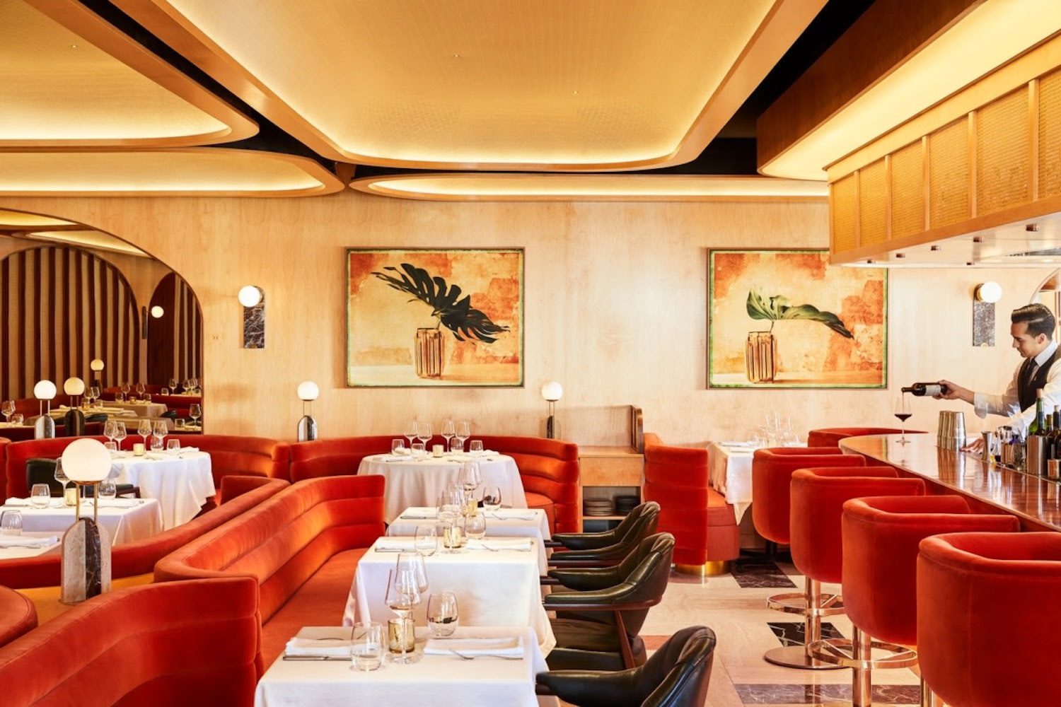 Interior of a restaurant with red and yellow hues.