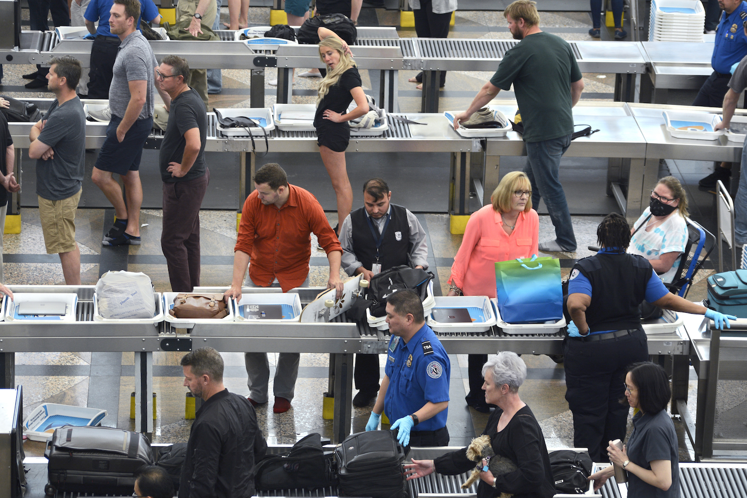 Airplane passengers proceed through the TSA security checkpoint at Denver International Airport
