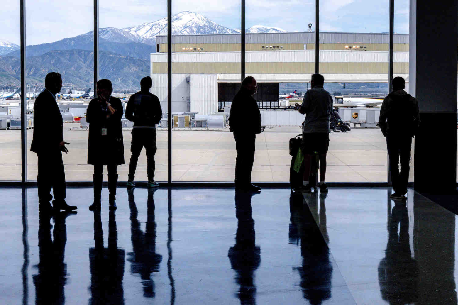 Passengers are silhouetted as they wait to board the inaugural flight from San Bernardino International Airport