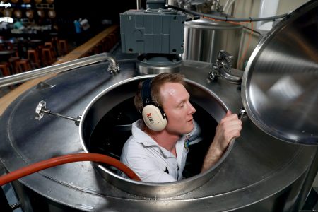 Dane Volek cleans a brew kettle at Anchor Public Taps on May 2, 2019.