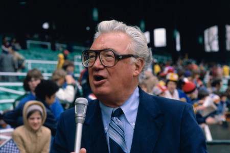 announcer Harry Caray talking into a microphone.