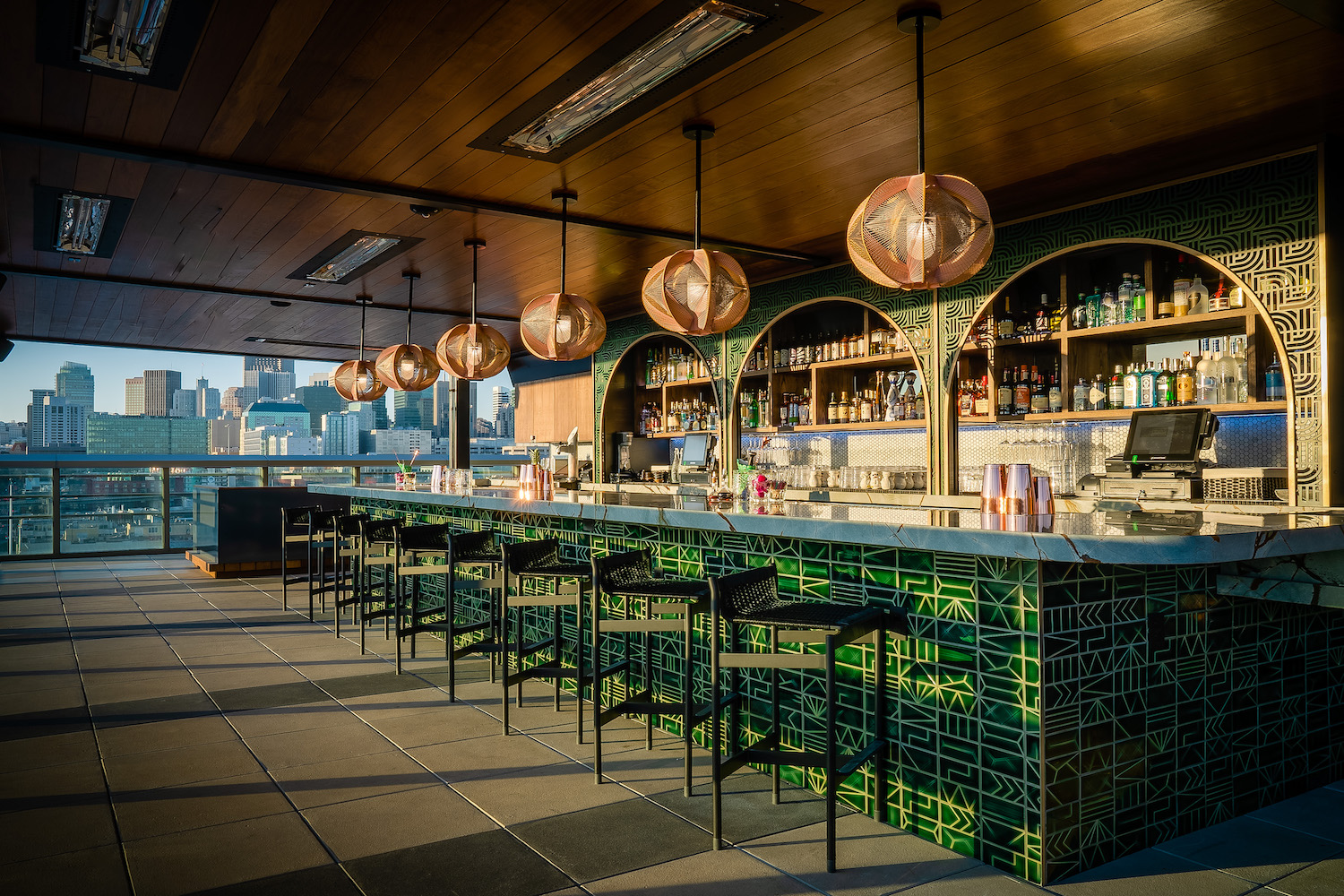 Green bar decorated vibrantly with view of city skyline
