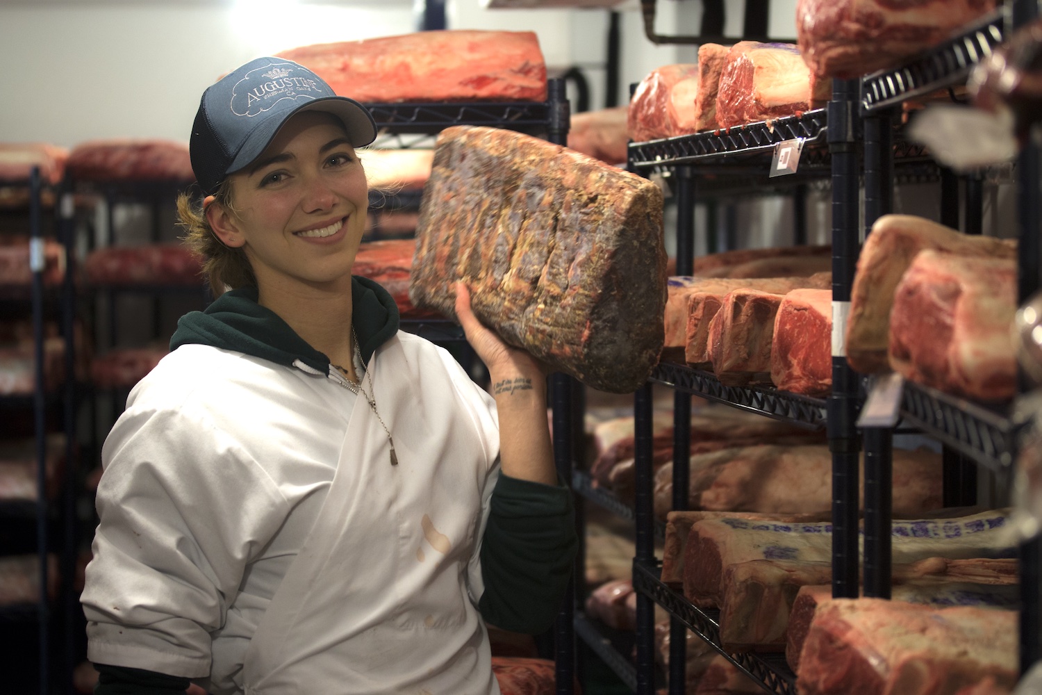 Katie Flannery posing with meat in her hand.