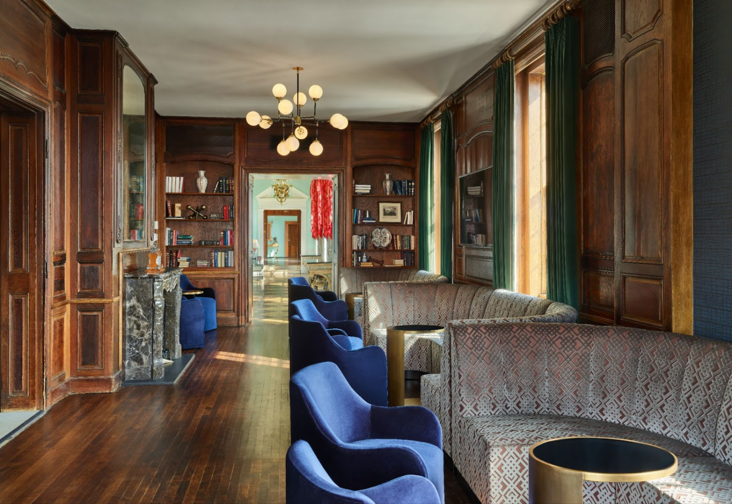 Blue chairs at tables in a library.