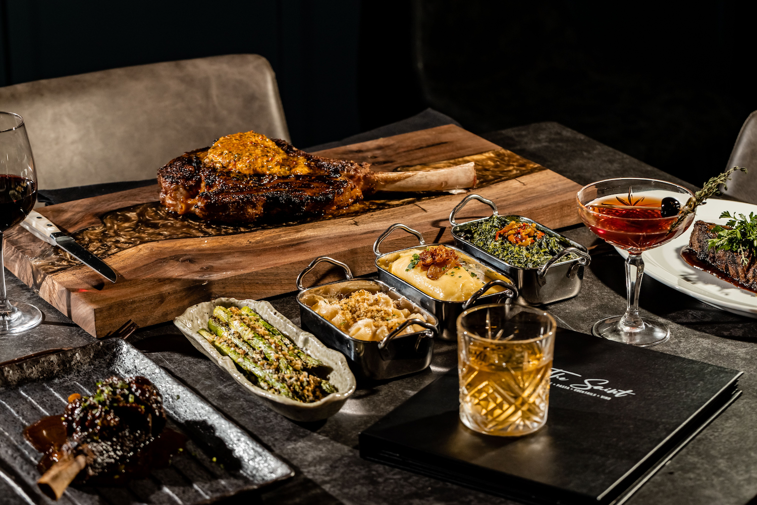 assorted trays of food on black table.