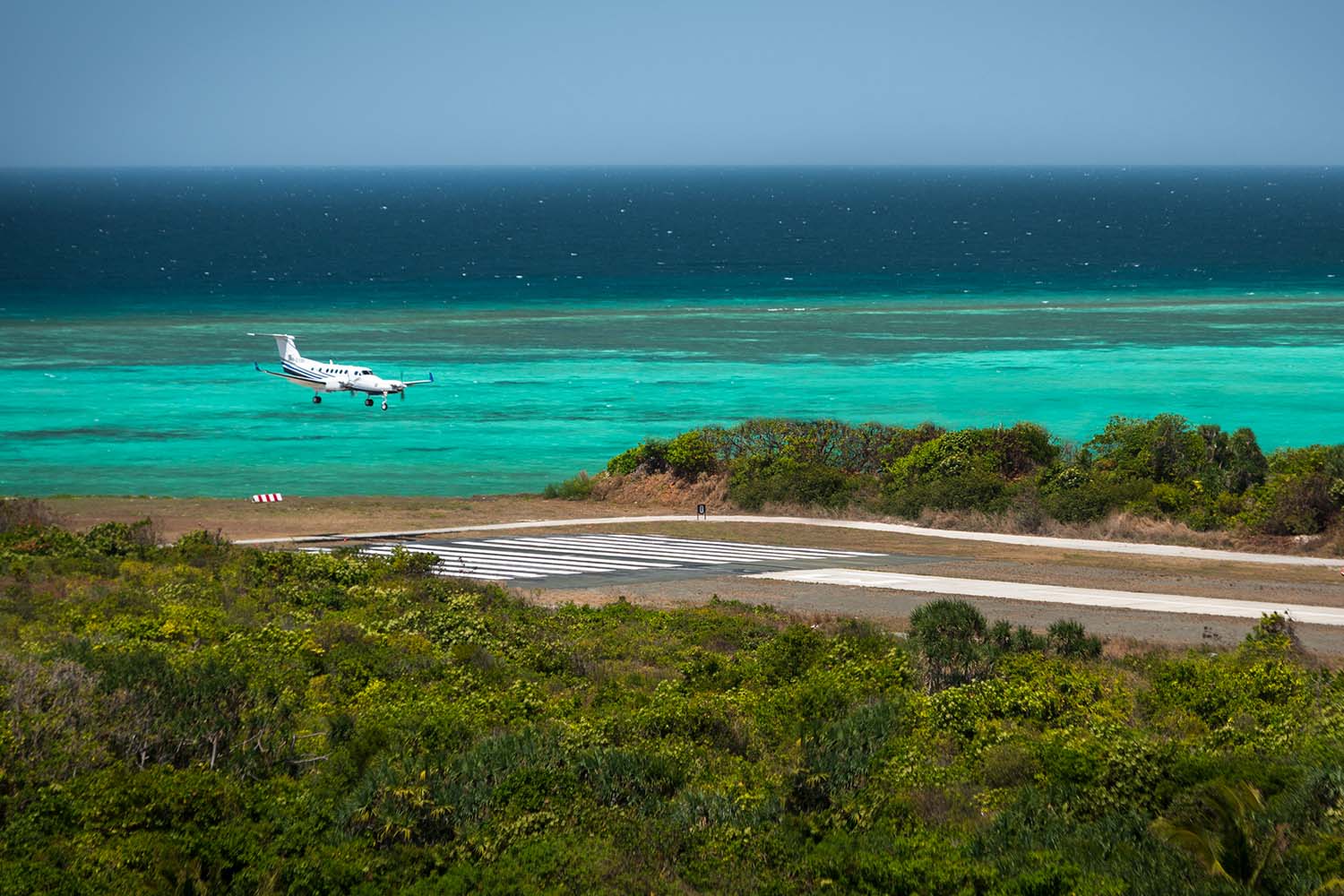 A turboprop jet landing on Pamalican