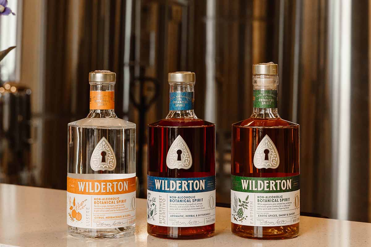 Three of Wilderton's non-alc bottles in front of the distillery