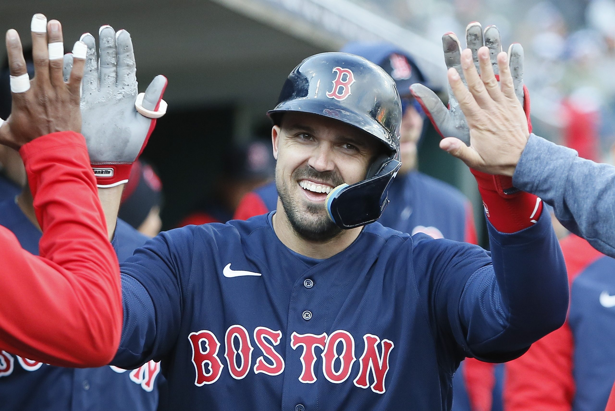 Adam Duvall of the Red Sox celebrates in the dugout after scoring.