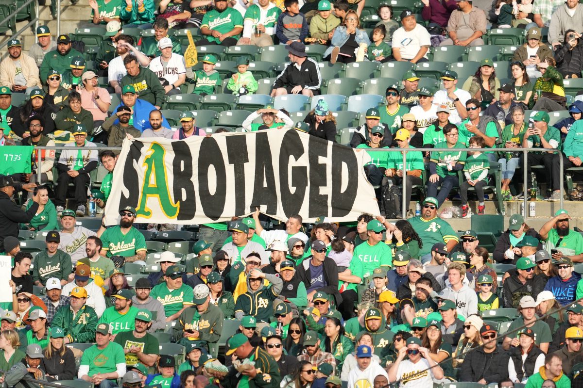 Oakland Athletics fans hold signs during a reverse boycott game against the Rays.