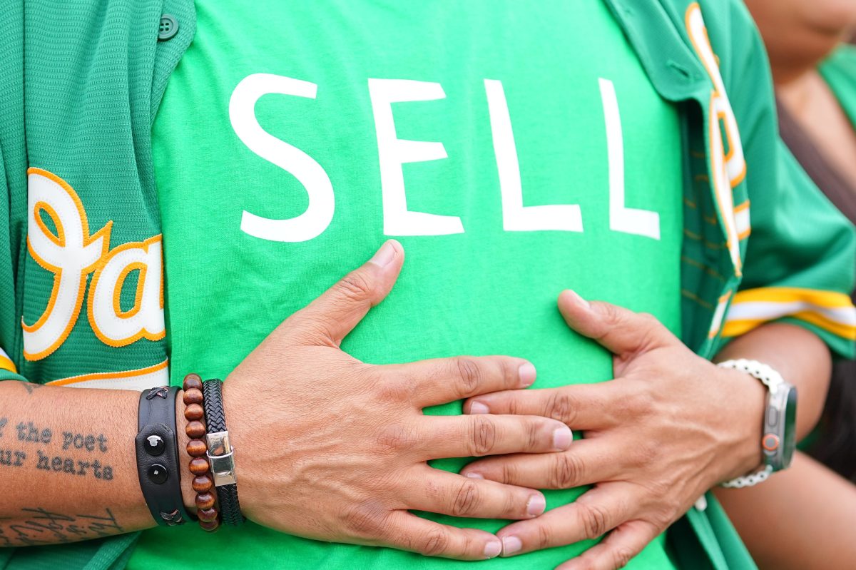 An Athletics fan wears a "SELL" shirt vs the Tampa Bay Rays.