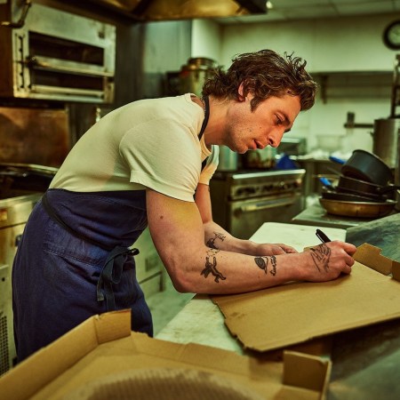 Jeremy Allen White as "Carmy" in "The Bear" writing on a box in a kitchen