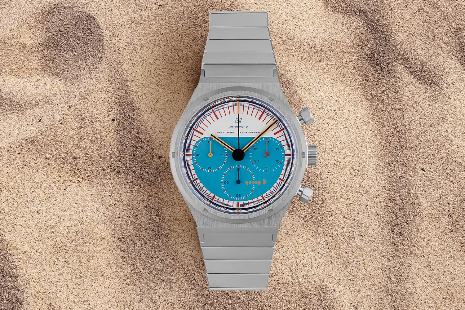 Blue and gray watch in the sand.