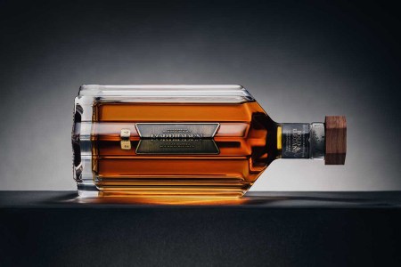 A bottle of Forbidden bourbon on its side