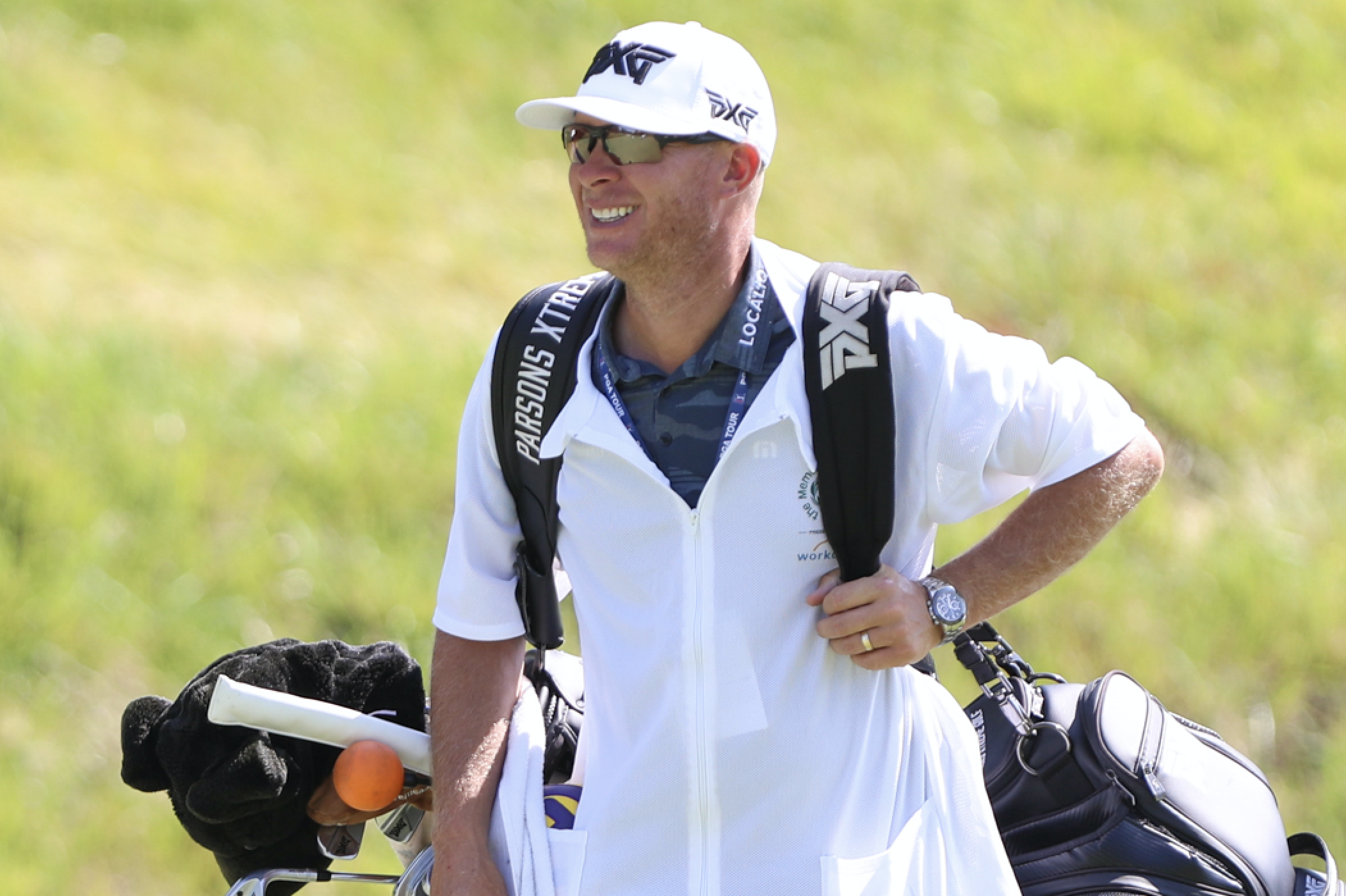 Geno Bonnalie on the course carrying Joel Dahmen's bags.