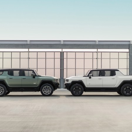 Side profile image of the 2024 GMC HUMMER EV Edition 1 SUV in Moonshot Green Matte (left) and the 2023 GMC HUMMER EV Edition 1 Pickup in Interstellar White (right).