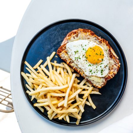 Croque Madame and fries on a plate.