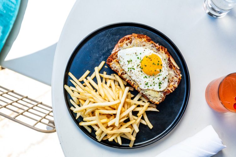 Croque Madame and fries on a plate.