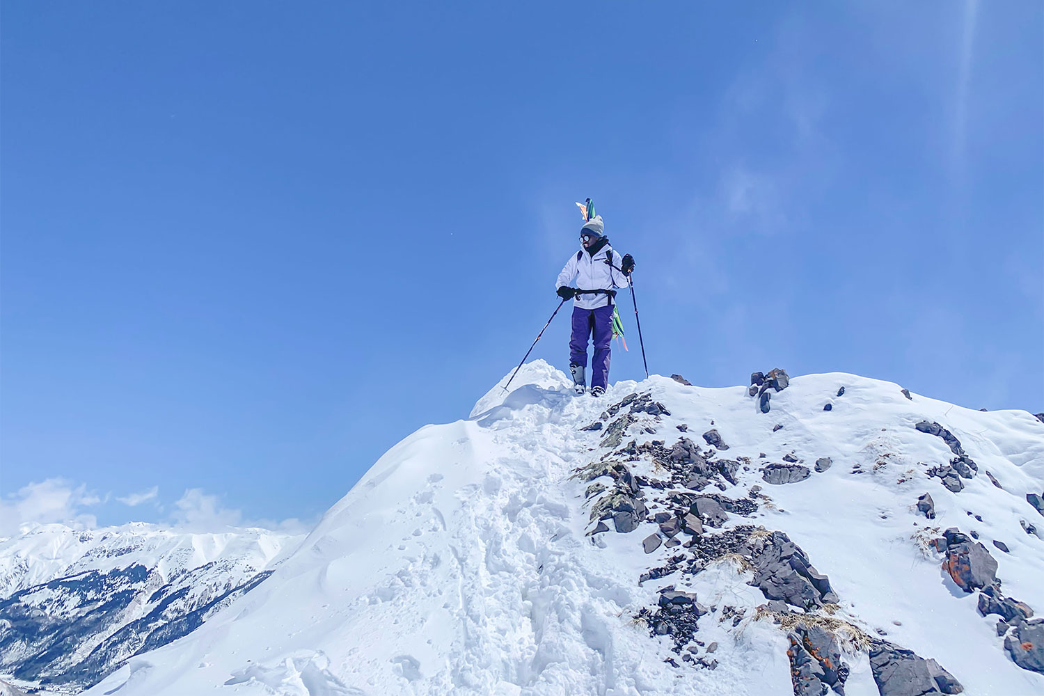 Joe Kanzangu in ski gear on top of Commodores outside of Silverton, Colorado
