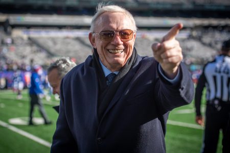 Cowboys owner Jerry Jones on the field reacting to fans.