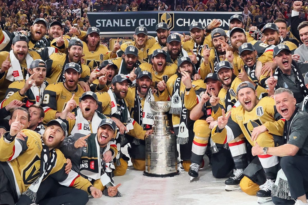 Members of the Vegas Golden Knights pose with the Stanley Cup.