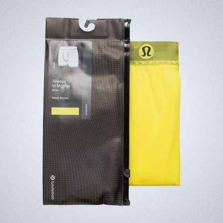 a pair of yellow lululemon Aim Boxers on a grey background