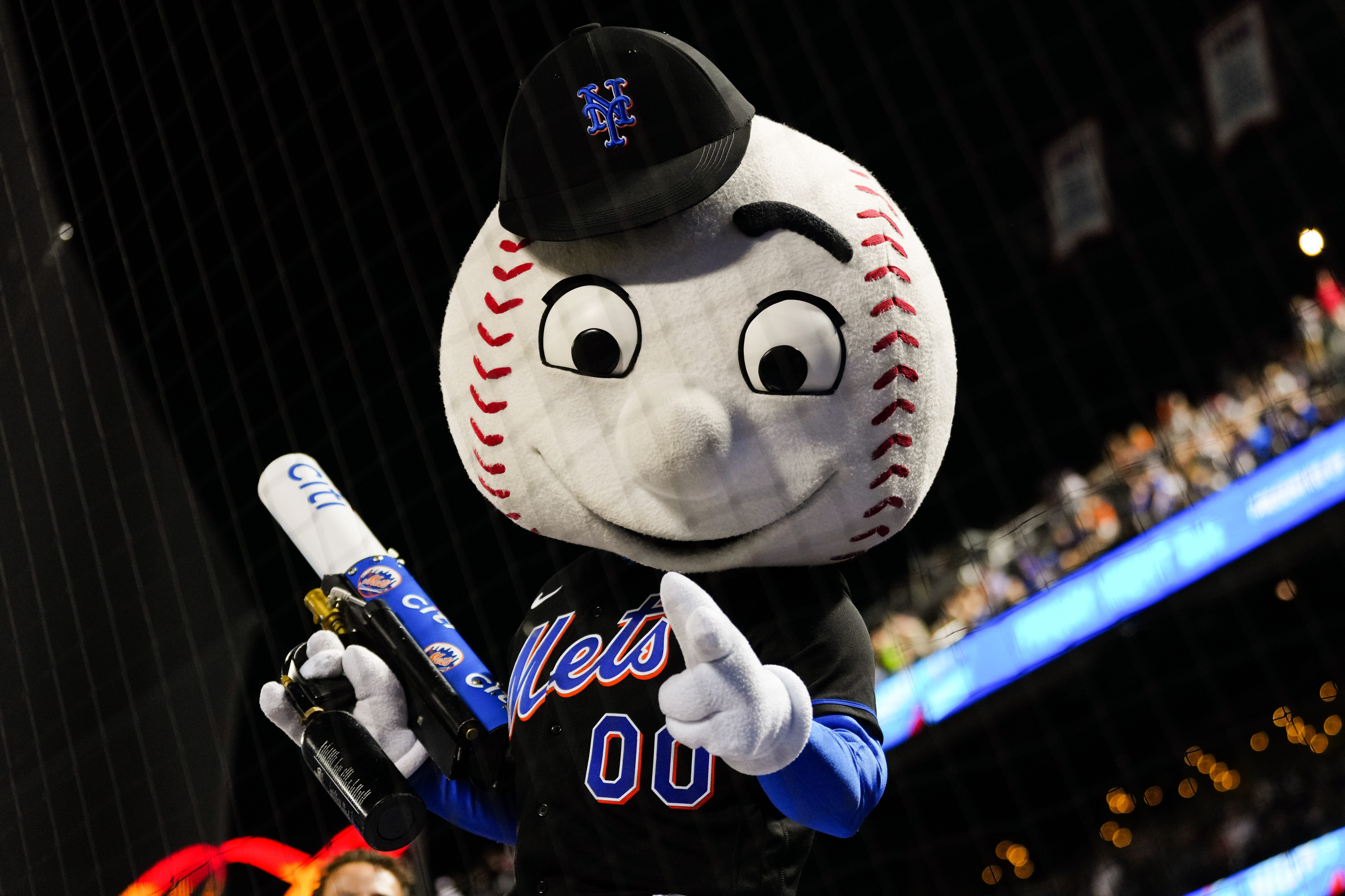 Mr. Met poses for a photo at a Mets game.