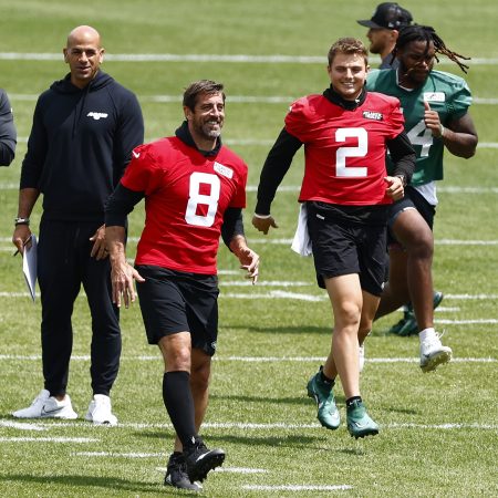 Aaron Rodgers and other New York Jets jog during the team's OTAs.