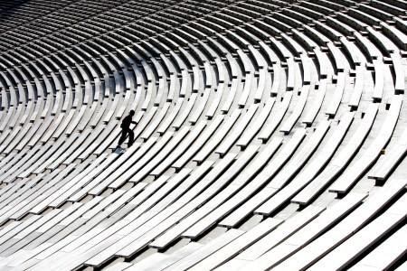 A man running up stairs in a stadium.
