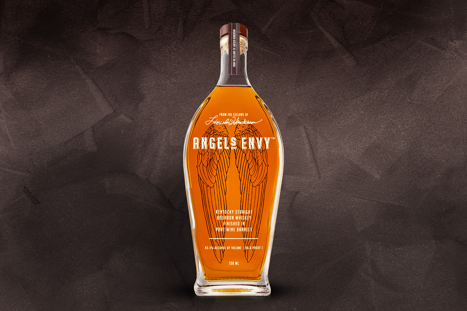 a bottle of angel's envy bourbon on a grey background