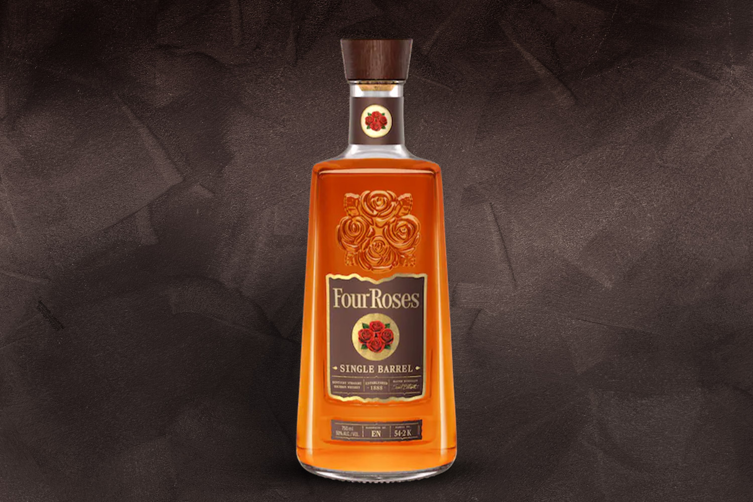 a bottle of four roses bourbon on a grey background