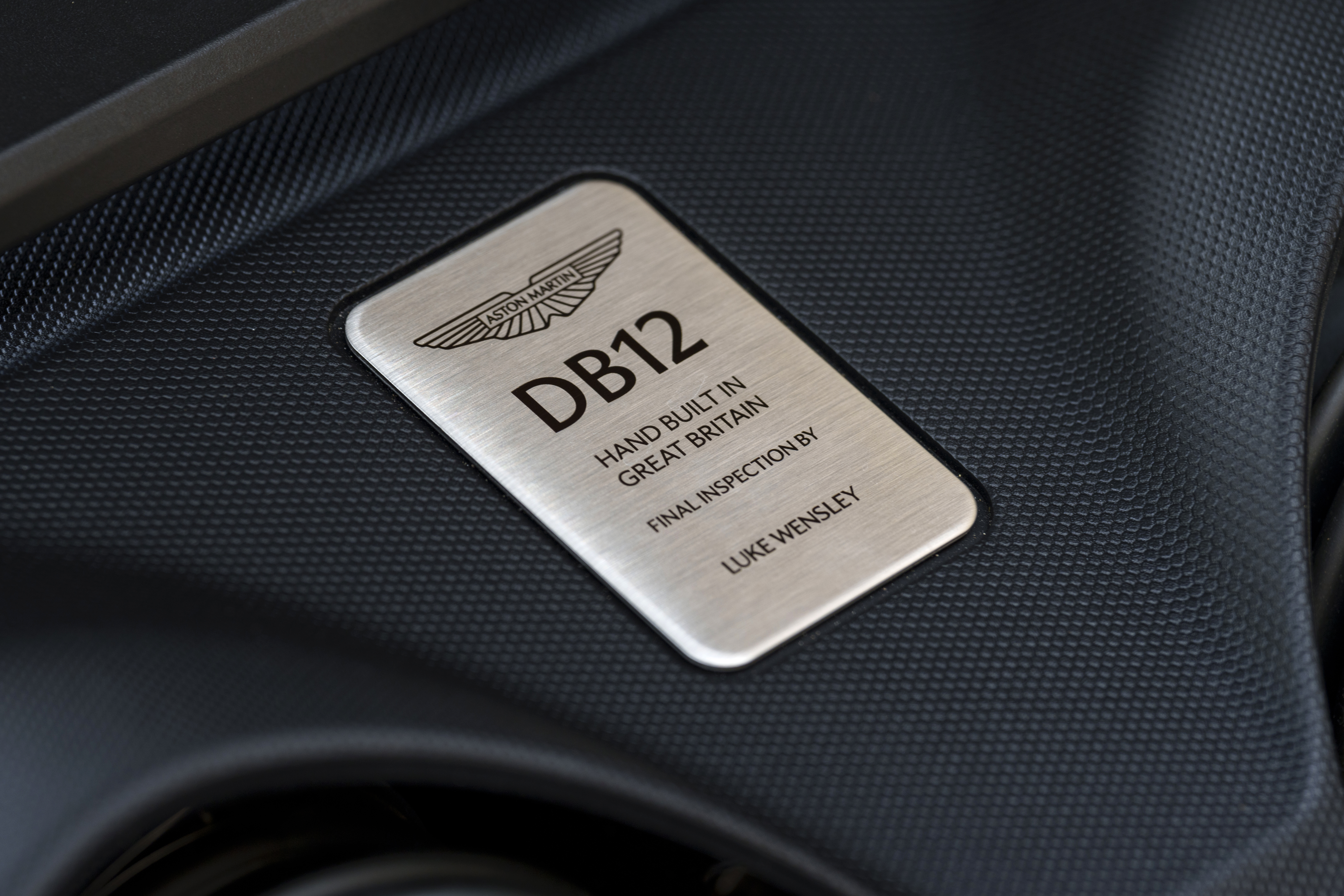 A small stainless steal plaque in the Aston Martin DB12 assures drivers of its quality, having been hand built in Great Britain and inspected