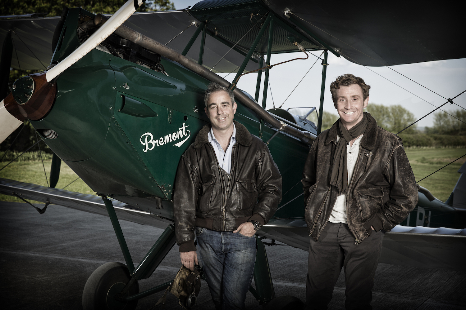 Giles English (left) and his brother Nick English standing in front of a small plane.