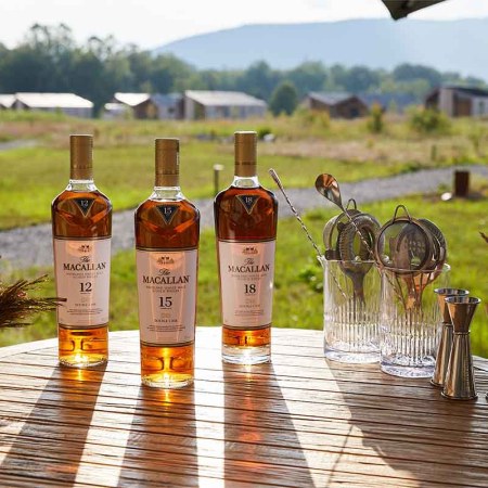 Three bottles of The Macallan on a table outside at Wildflower Farms in Hudson Valley. The Scotch brand is now offering luxury relaxation trips upstate.
