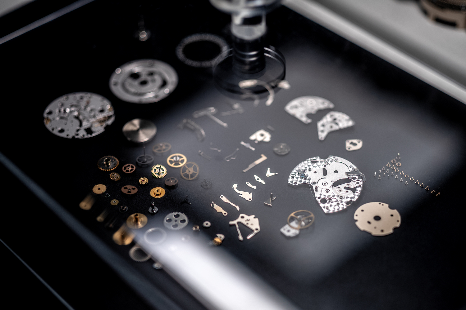 Watch parts on display in a case.