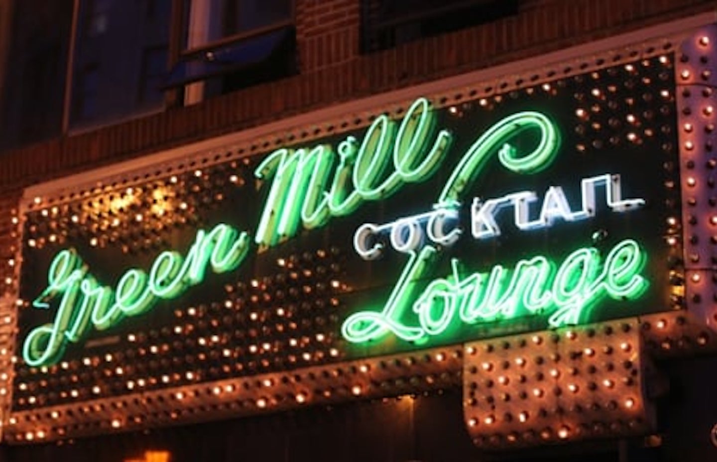 Neon green sign for Green Mill bar