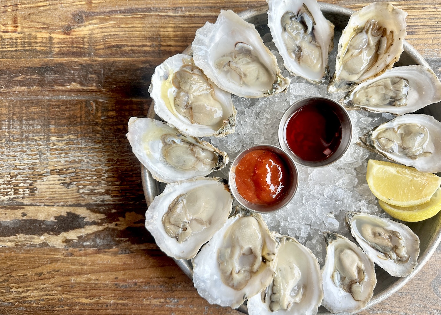 Oysters on ice with sauces.