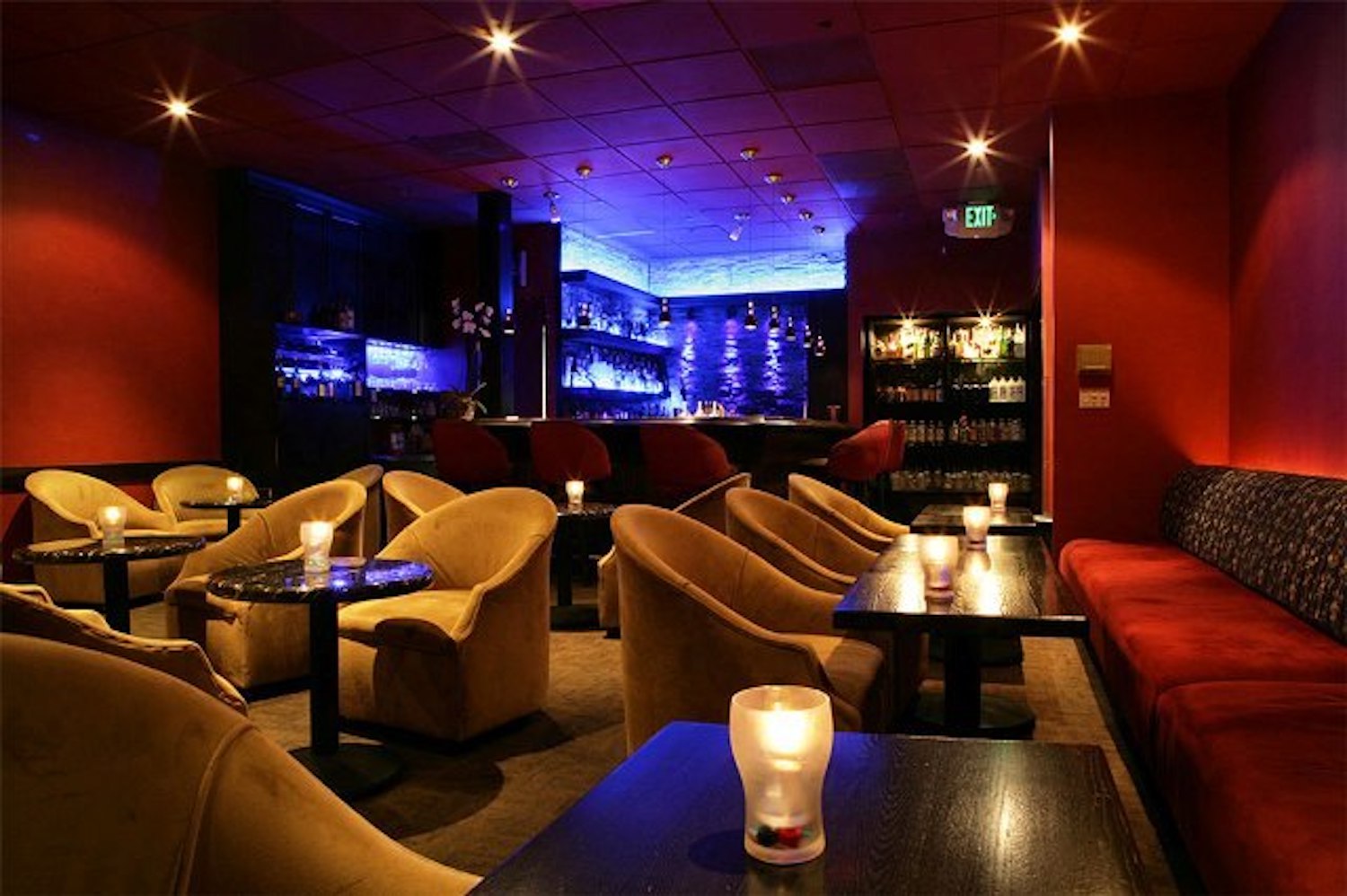 Dark bar area with candles and lounge chairs
