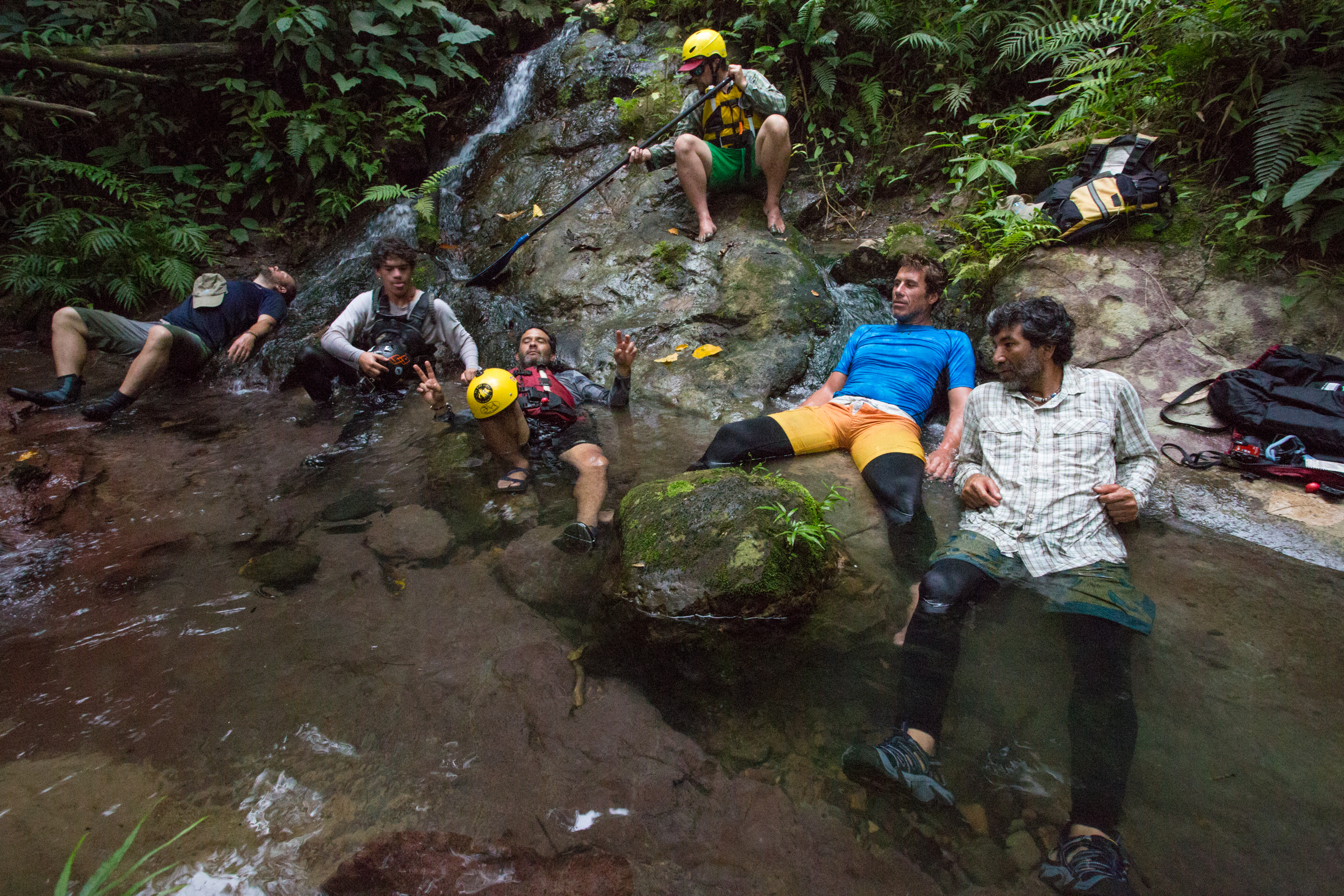A group of SUP adventurers relax on a bank of the Madre de Dios river