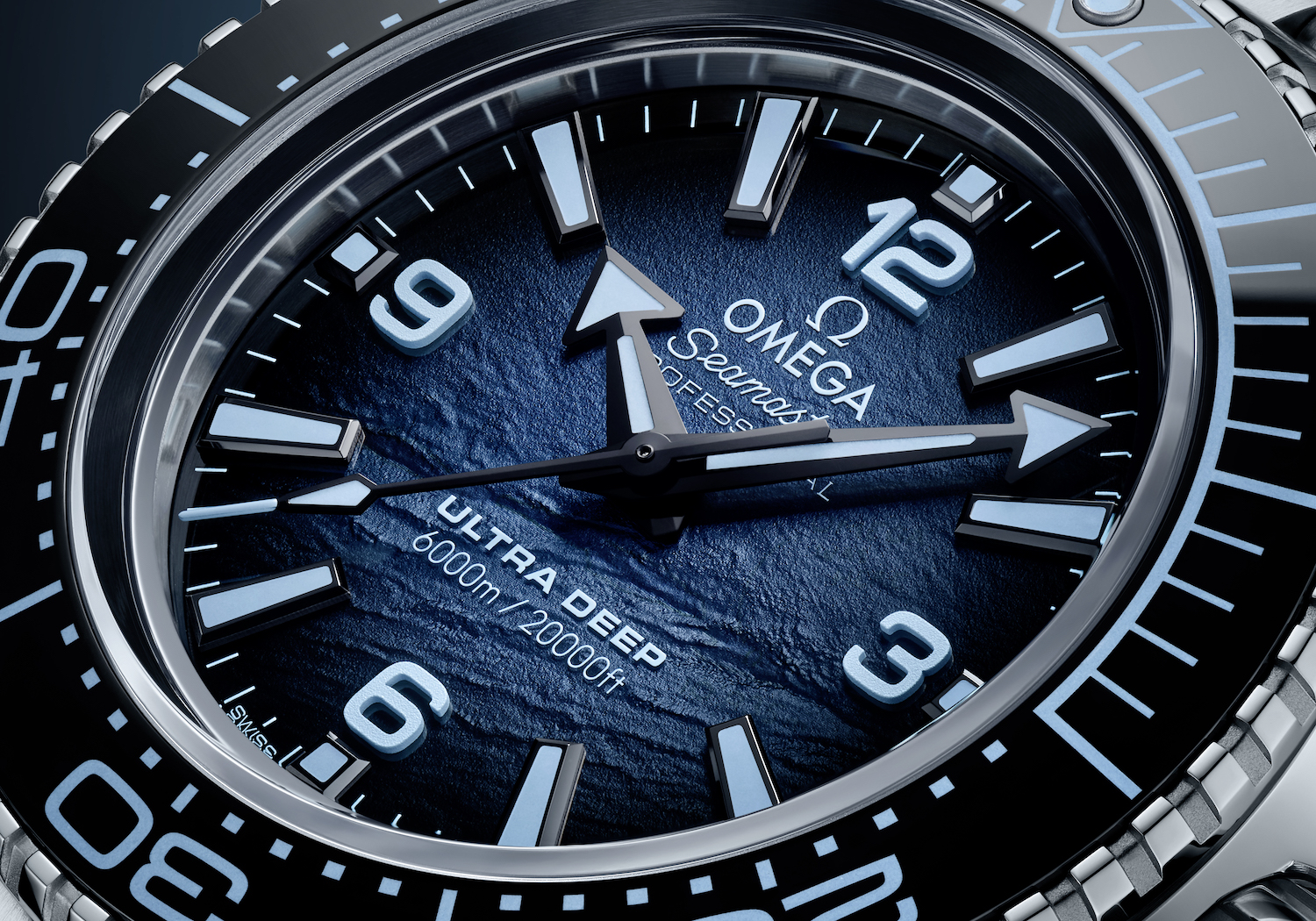 Close-up of silver and blue watch designed like the ocean