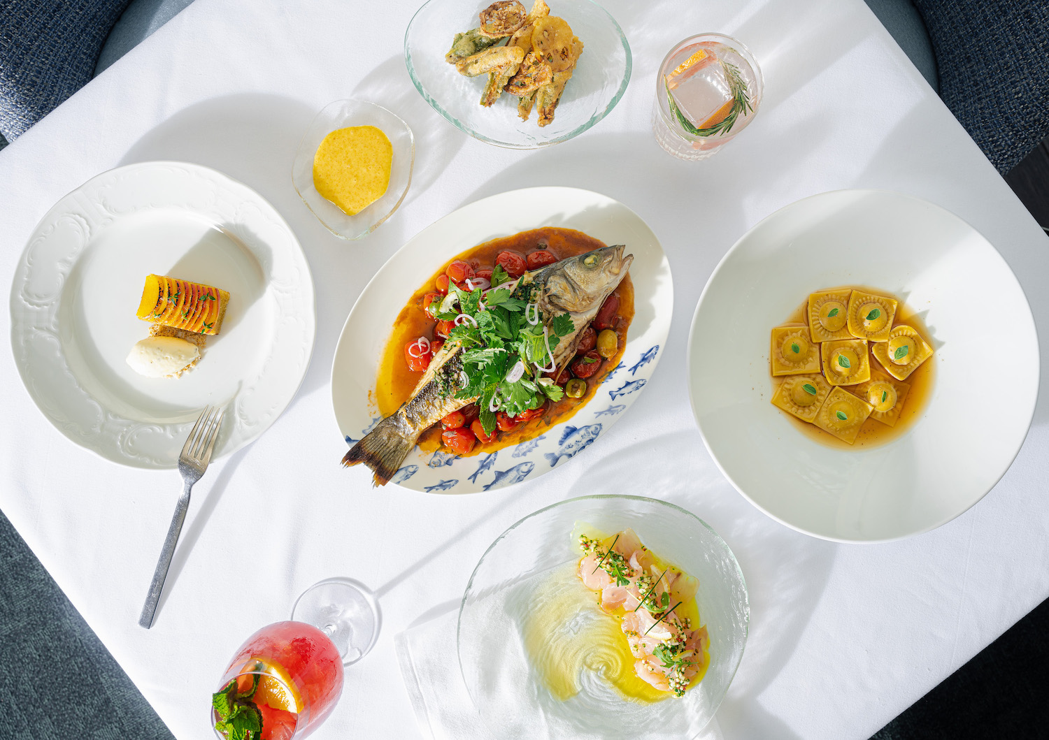 Spread of food with a fish at the center of the table. texas best new restaurants
