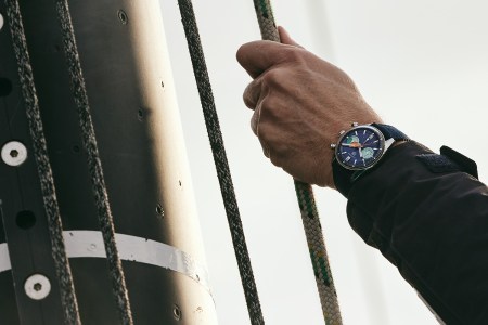 A man pulling a rope wearing the new TAG Heuer chronographic watch.